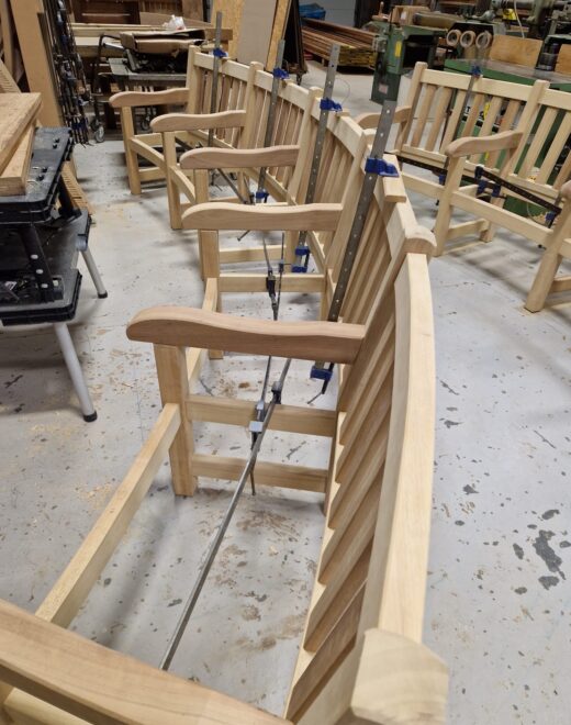 Detailed view of curved bench frame under assembly