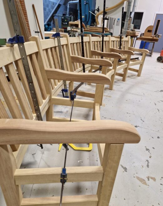 Curved York bench clamped during assembly in Woodcraft UK workshop