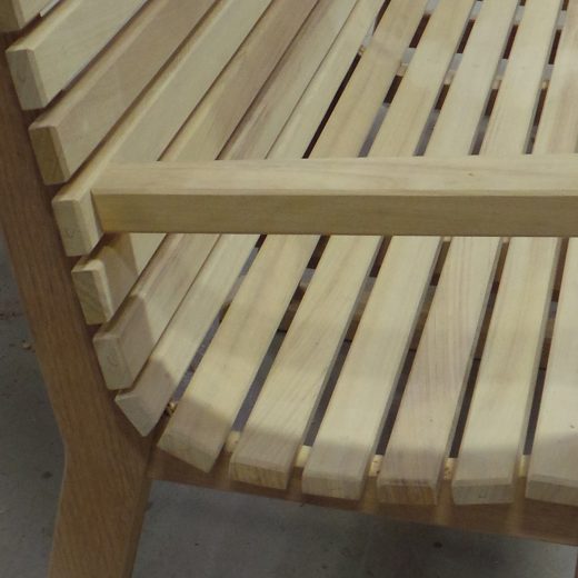 Close up showing the curve of the seat slats of the Regent wooden bench