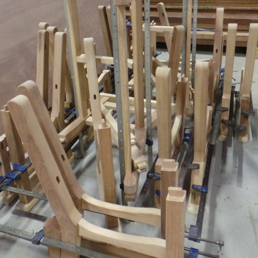 A mass of Regents Park bench components being assembled.