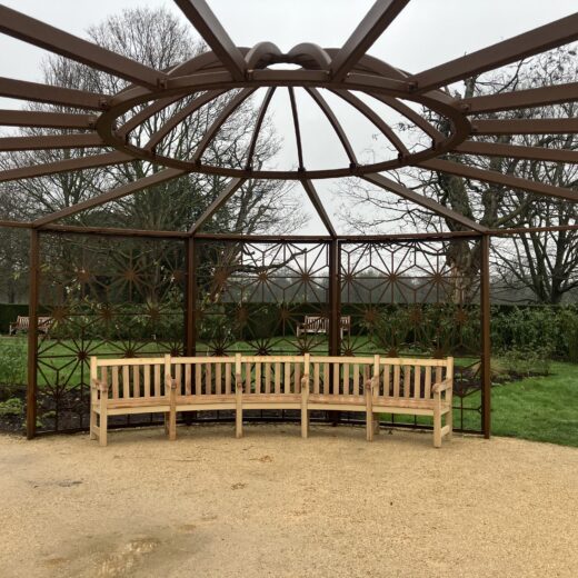 Curved York memorial bench installed beneath pergola in Rose Garden, Greenwich Park