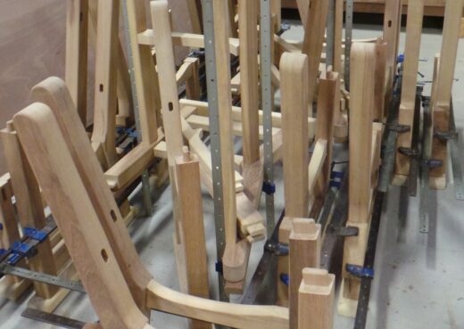 A mass of Regents Park bench components being assembled.