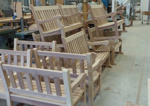 Wooden back to back benches awaiting transport to St James' park London