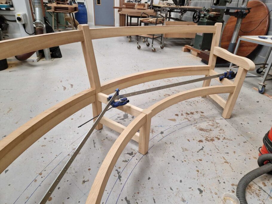 Curved Scarborough bench frame during early assembly at Woodcraft UK workshop.