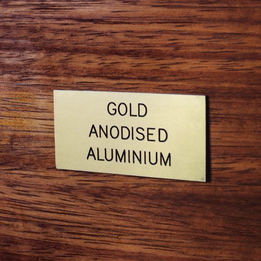 Gold anodised aluminium badge