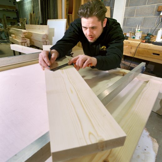 Woodcraft UK's craftsman measuring up a length of timber ready for cutting.