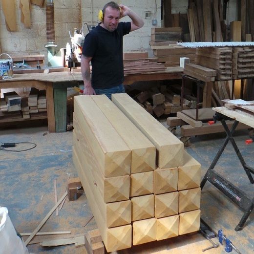 A Woodcraft craftsman manufacturing wooden bollards