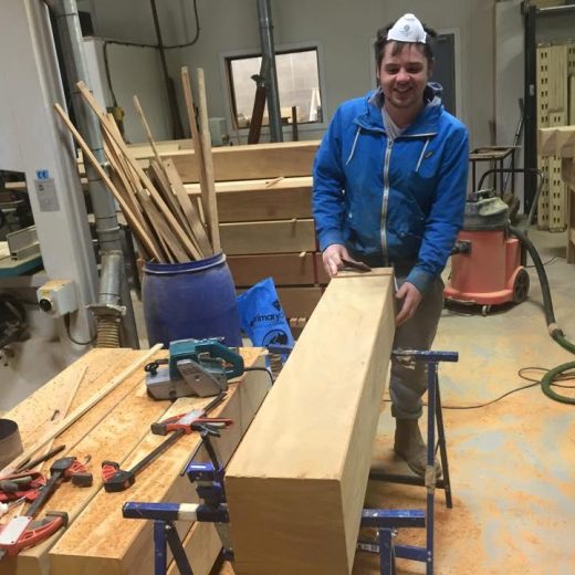 Luke taking timeout from sanding a wooden bollard