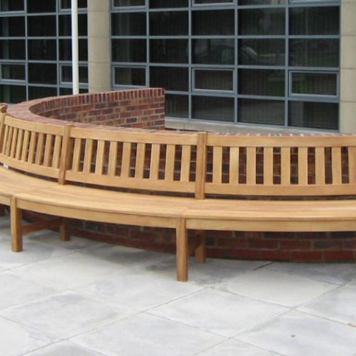 A bespoke curved wooden bench designed for street seating