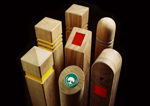 An assortment of seven bollards with reflective strips and badges