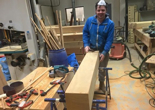Luke taking timeout from sanding a wooden bollard